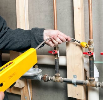 plumber scanning a pipe for leaks