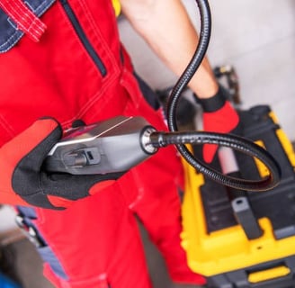 a plumber showing his advanced leak detector