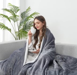girl drinking tea in gray electric throw 