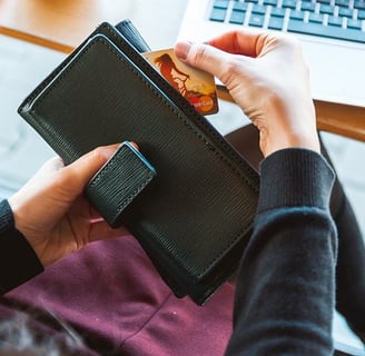 A person taking a credit card out of wallet.