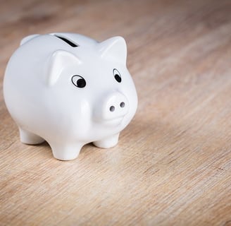 white piggy bank on a wooden desk