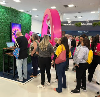 a group of people standing around a television screen