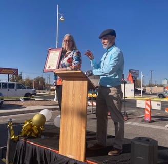 President of DCCNM holding Audrey Nelson Award at grand opening 