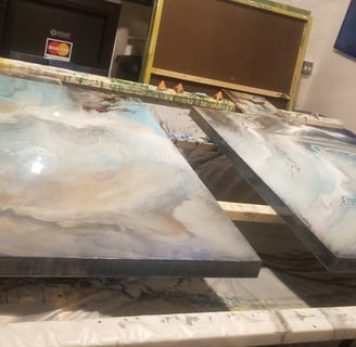 two large paintings of a painting of a wave