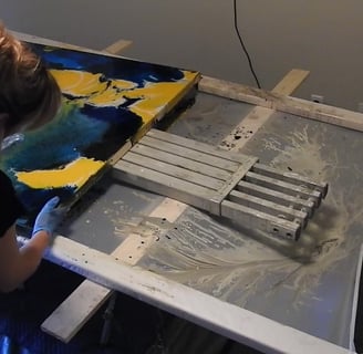 a woman is painting a large piece of art