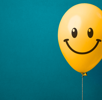a yellow balloon with a smiley face on it