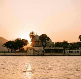 a boat in the water with a sunset in the background