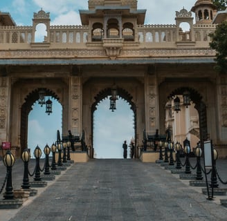 a large archway with a clock tower in the middle of a paved road