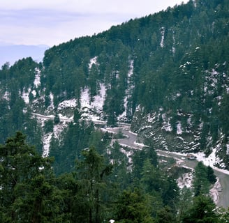 a mountain scene with a winding road and a winding road