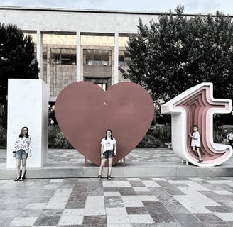 kids in front of 1 heart tirana sign in albania
