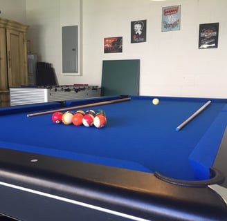 a pool table in a games room in florida villa