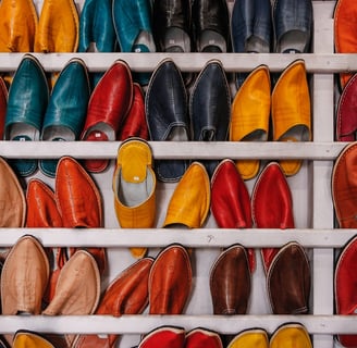 Image showing a bunch of different colour shoes that are sitting on a shelf