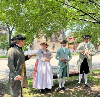 Colonial costumed villages chatting in the street in Williamsburg
