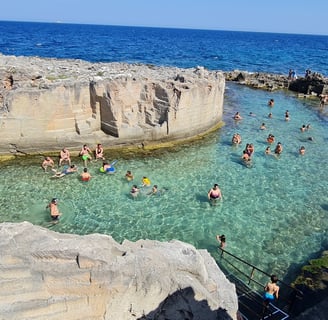 "Grotta della Poesia, Puglia—natural limestone swimming pool with crystal-clear waters, surrounded b