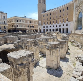 "Roman amphitheater in Lecce, Italy—ancient ruins in the heart of the city, showcasing historic arch