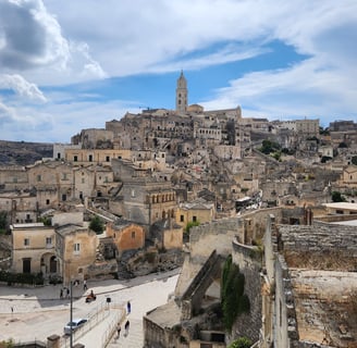 "Ancient stone city of Matera, Italy, featuring historic Sassi cave dwellings and breathtaking lands