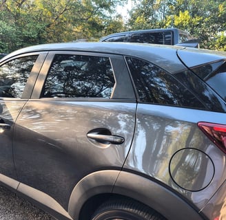a car parked in a parking lot with a roof rack