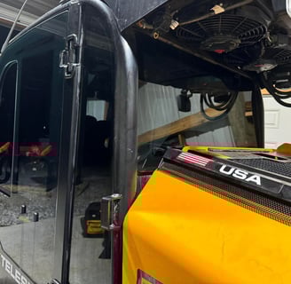 a yellow bulldozer is parked in a garage