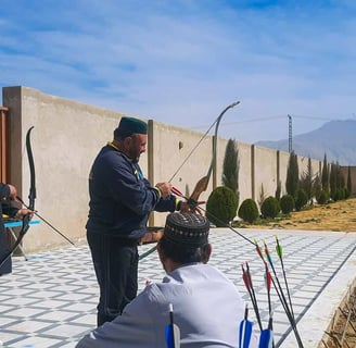 a man is holding a bow and aiming at a target
