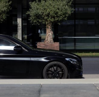 a black car parked on the side of the road