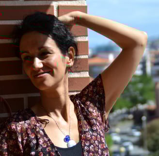a woman in a floral dress standing on a balcony beatriz Alvarez