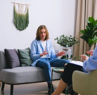 a woman sitting on a couch in a living room