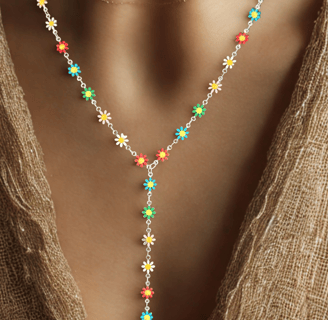 a woman wearing a necklace and a necklace with a flower