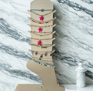 a display of jewelry with a wooden display case