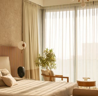 a bedroom with a bed and chairs and a chandelier