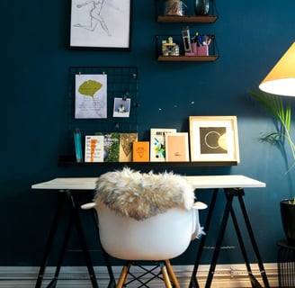 a desk with a chair and a lamp