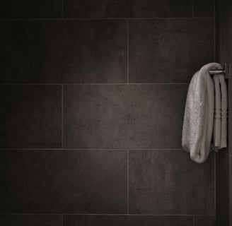 a towel hanging on a wall in a bathroom