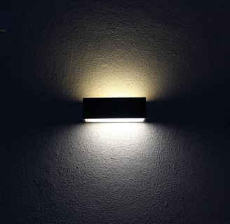 a wall light with a small square light on it