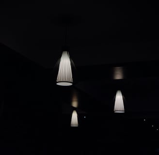 a group of three lamps hanging from a ceiling
