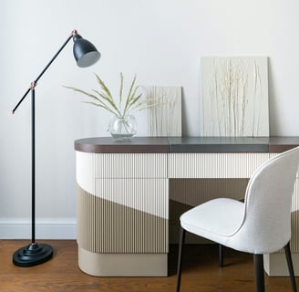 a desk with a lamp and a lamp on a table