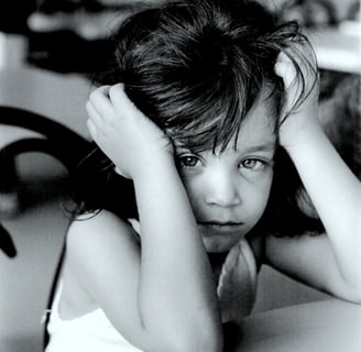 Tired little girl black and white photo hands on head
