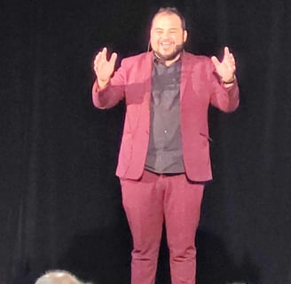 a man in a suit and tie standing on a stage