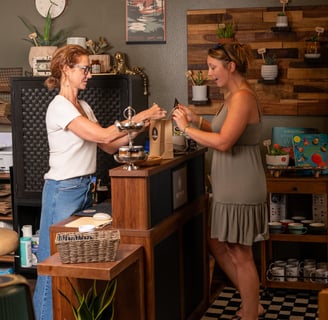 Cashier and a happy customer at the register of a boutique