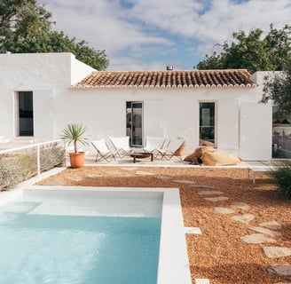 Swimming pool in the back yard of a white house in Portuguese countryside
