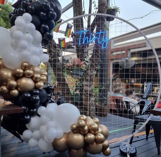 Circle backdrop, Thirty neon, gold black and white garland at 30th birthday at Brunswick Hotel.