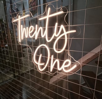Twenty One neon sign lit up to match the gold theme at Kaea's 21st birthday party in Brisbane.