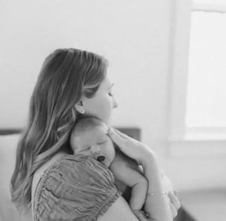 a woman holding a baby in her arms