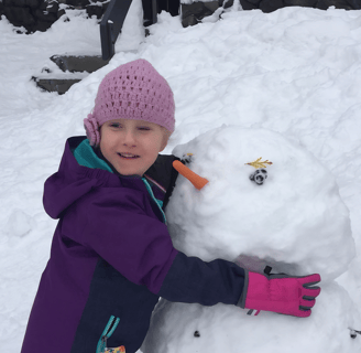 girl building snowman