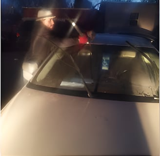 Technichian is working after dark on a windshield