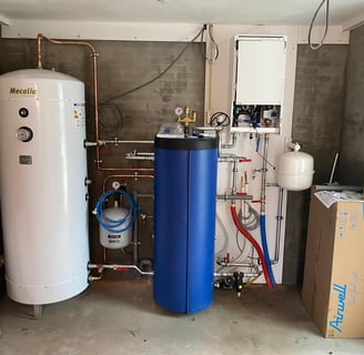 a room with a tankless water heater and a large blue tank