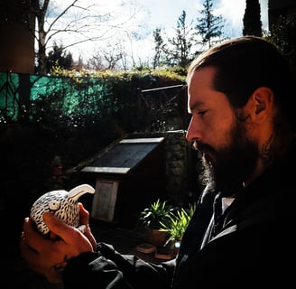 a man with a beard and a bird on his hand