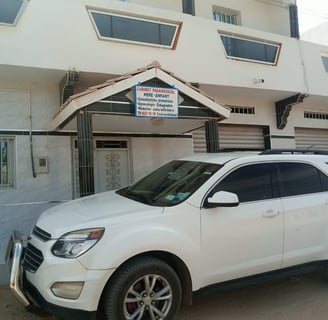 a white suv parked in front of a building