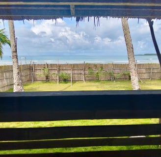 View from the deck at Afulu Surf Resort, overlooking the ocean with stunning sunsets.