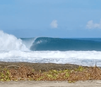 Perfect barreling wave in front of Afulu Surf Resort