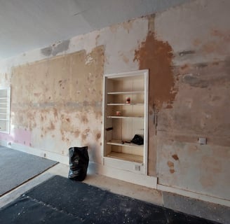 a wall during renovations with holes filled before papering