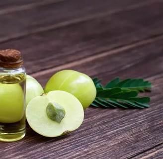 Amla oil bottle with fresh amla fruits, representing natural hair growth and health benefits.